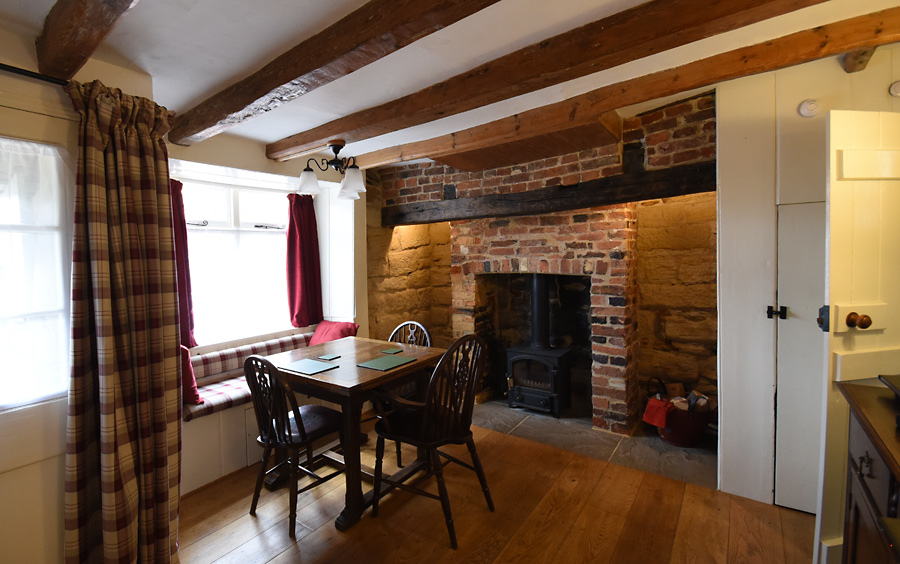 Dining table seat six, window seat stane and brick fire place with large bressummer beam