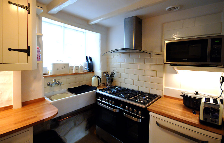 Compact kitchen design with all modern amenities including dish washer and microwave