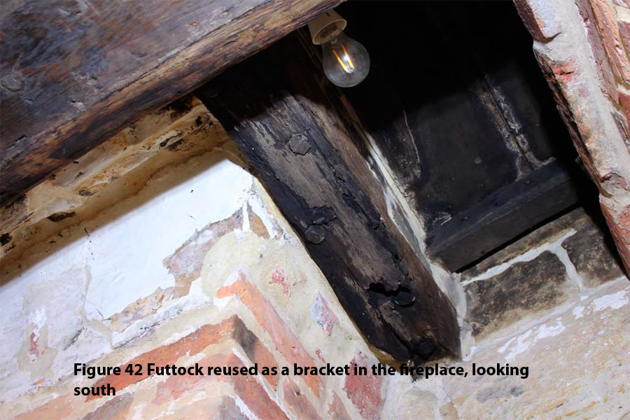 Figure 42 Futtock reused as a bracket in the fireplace, looking south