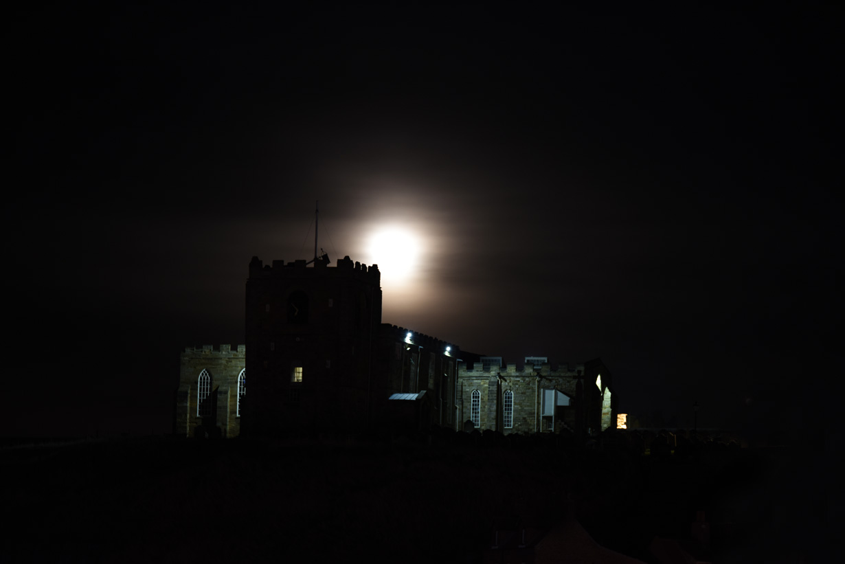 Moon rising above Saint Mary's Church viewed at the right time from this harbour cottage Whitby